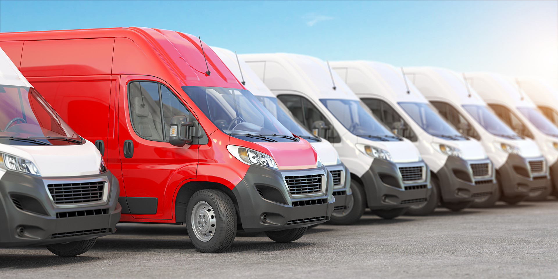 Red delivery van in a row of white vans